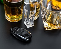 Alcohol and a car key on a table - DUI attorney Long Beach, CA